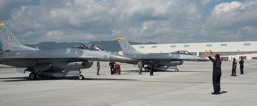 U.S. Air Force Staff Sgt. Steven Pedrick, a Pacific Air Forces F-16 Demonstration Team dedicated crew chief, marshals Maj. Richard Smeeding, the PACAF F-16 Demonstration Team pilot, at Marine Corps Air Station Iwakuni, Japan, May 22, 2017. The team's objective is strengthening the U.S. Air Force's relationship with countries in the Indo-Asia-Pacific region through showcasing the pinnacle of the Air Force’s core values: integrity first, service before self, and excellence in all we do. (U.S. Air Force photo by Staff Sgt. Melanie Hutto)