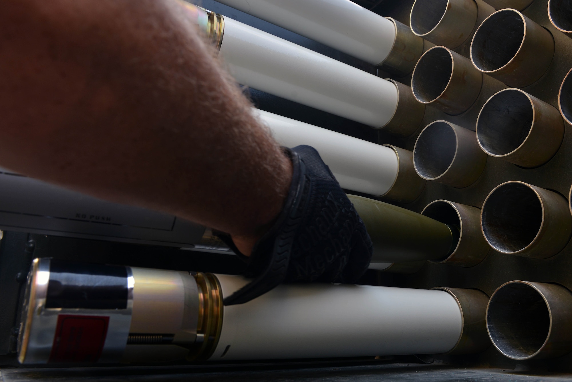 U.S. Air Force Tech. Sgt. Jeremiah Webb, 447th Expeditionary Aircraft Maintenance Squadron maintenance supervisor, racks an Advanced Precision Kill Weapon System (APKWS) rocket, May 24, 2017, at Incirlik Air Base, Turkey. The APKWS rockets were stored on a delivery system to be transported for aircraft installment. (U.S. Air Force photo by Senior Airman John Nieves Camacho)