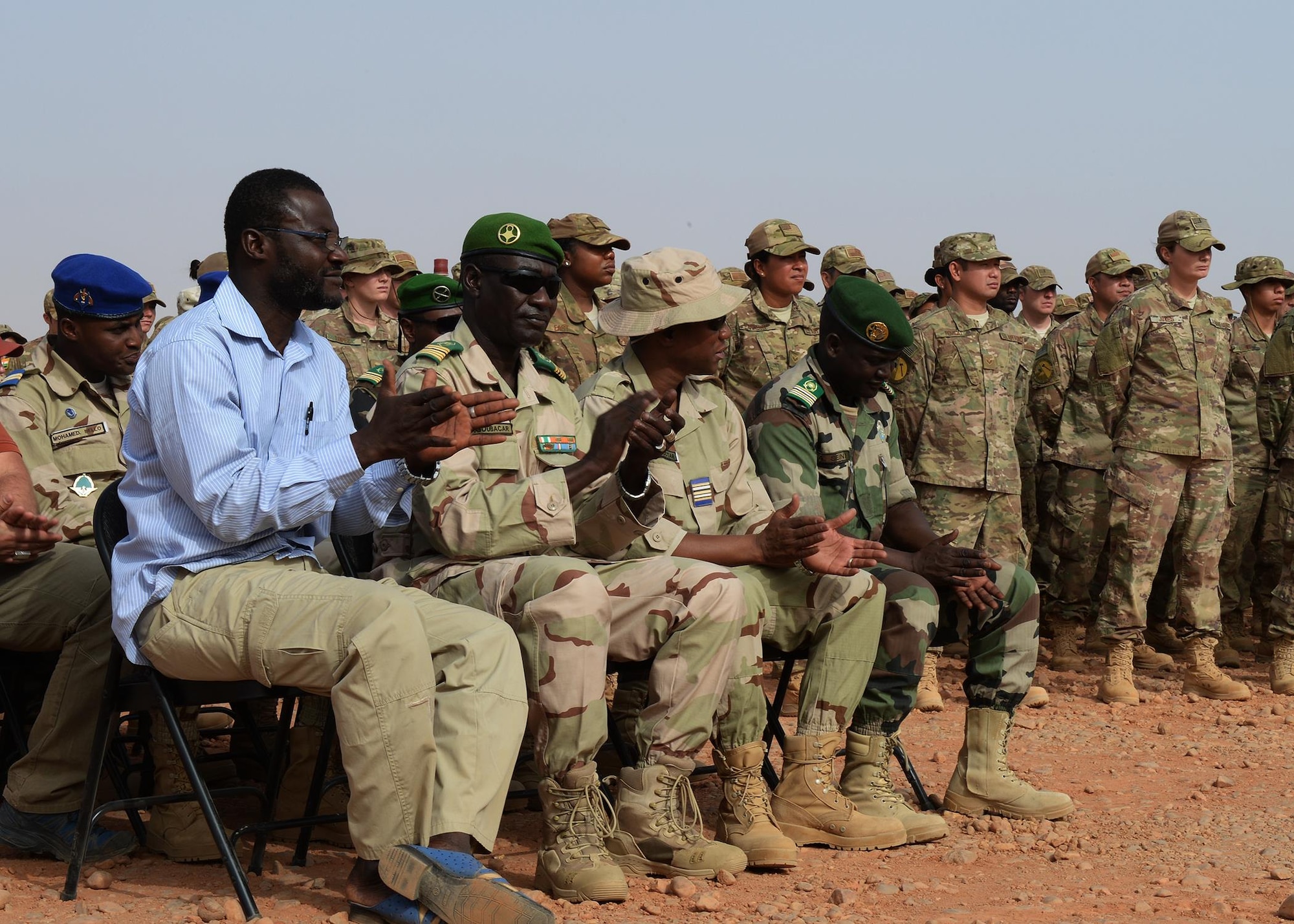 Leaders from the Forces Armées Nigeriennes applaud during the 724th Expeditionary Air Base Squadron’s change of command at Nigerien Air Base 201, Niger, May 15, 2017. The Air Force and the FAN continue to build their trust and partnership by attending events such as the change of command. (U.S Air Force photo by Senior Airman Jimmie D. Pike)