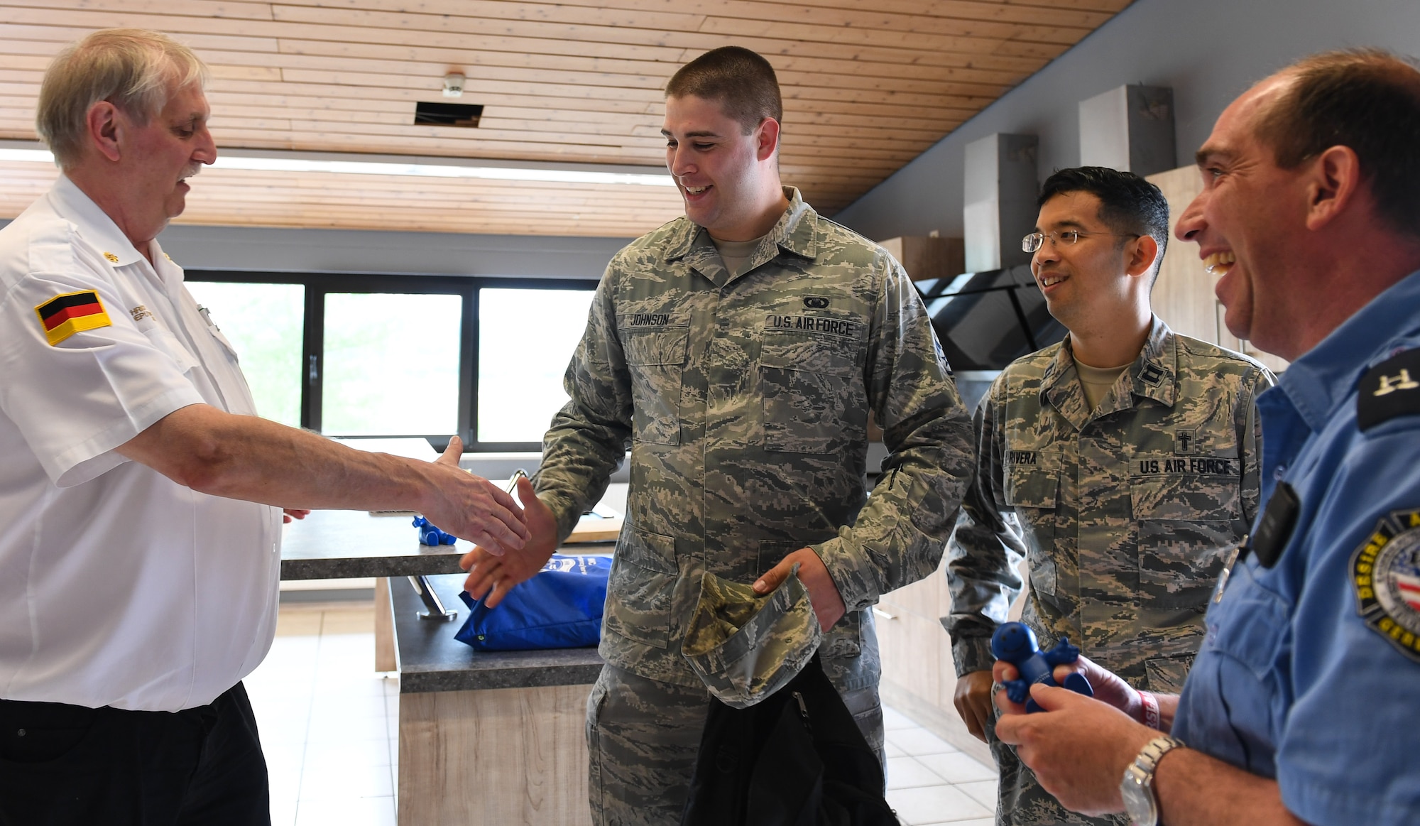 U.S. Air Force Staff Sgt. Jacob Johnson, 86th Airlift Wing Chapel education and training noncommissioned officer in-charge, center, shakes hands with 86th Airlift Wing personnel as part of a religious support team during a unit engagement on Ramstein Air Base, Germany, May 18, 2017. Johnson earned the U.S. Air Force Chaplain Corps Richard C. Schneider Award for 2016 outstanding chaplain assistant airman for his exceptional duties at Edwards Air Force Base and Ramstein AB. (U.S. Air Force photo by Staff Sgt. Nesha Humes)