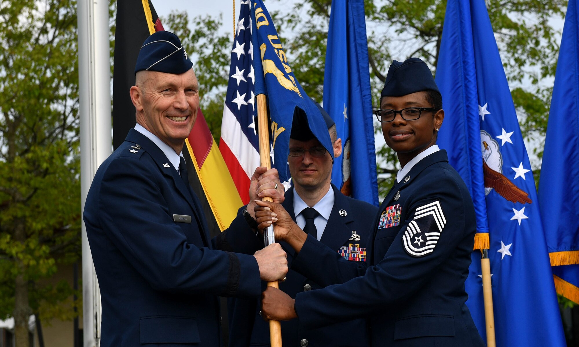 U.S. Air Force Chief Master Sgt. Tamar Dennis, outgoing Kisling Noncommissioned Officer Academy commandant, relinquishes the guidon to U.S. Air Force Maj. Gen. Timothy M. Zadalis, U.S. Air Forces in Europe and Air Forces Africa vice commander, during the academy’s Change of Responsibility ceremony on Kapaun Air Station, Germany, May 25, 2017. Dennis relinquished responsibility of the academy to U.S. Air Force Chief Master Sgt. Kathi Glascock, incoming Kisling NCOA commandant. A change of responsibility ceremony is the enlisted version of an officer’s change of command. (U.S. Air Force photo by Senior Airman Tryphena Mayhugh)