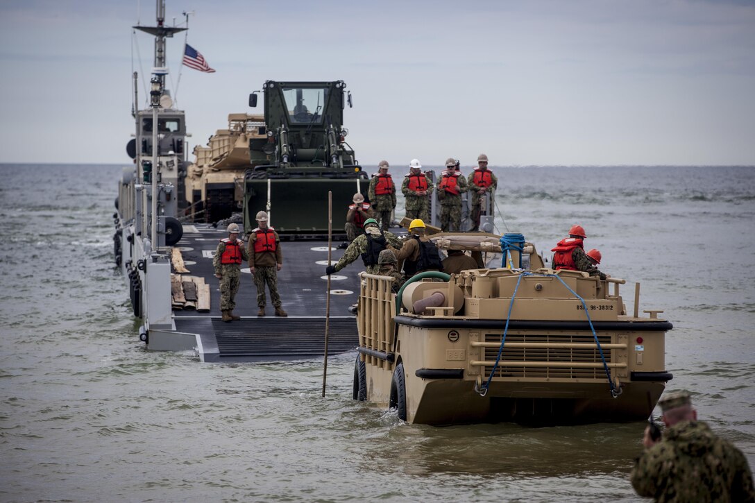 VENTSPILS, Latvia - U.S. Sailors with Navy Cargo Handling Battalion One, conduct the off-loading of tanks during exercise Saber Strike 17 in Ventspils, Latvia, May 24, 2017. Exercise Saber Strike 17 is an annual combined-joint exercise conducted at various locations throughout the Baltic region and Poland. The combined training prepares allies and partners to respond more to regional crises and meet their own security needs by improving the security of borders and countering threats. (U.S. Marine Corps photo by Lance Cpl. Ricardo Davila/Released)