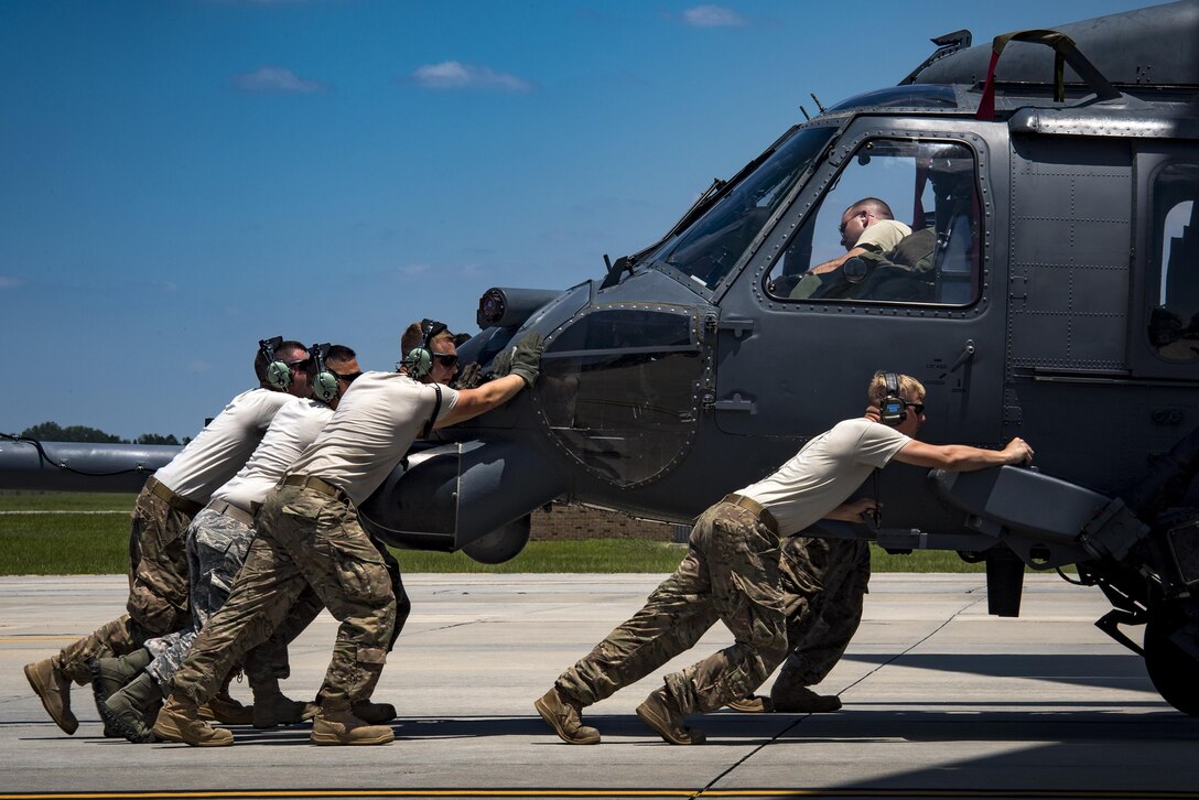 Airmen from the 41st Helicopter Maintenance Unit push an HH-60G Pave Hawk into a C-17 Globemaster III, May 15, 2017, at Moody Air Force Base, Ga. Loading the helicopter for transport was the first step in a rapid-rescue exercise conducted at Langley AFB, Va., which was designed to test the maintainer’s and aircrew’s ability to quickly set up and conduct rescue operations away from their home station. (U.S. Air Force photo/Staff Sgt. Ryan Callaghan)