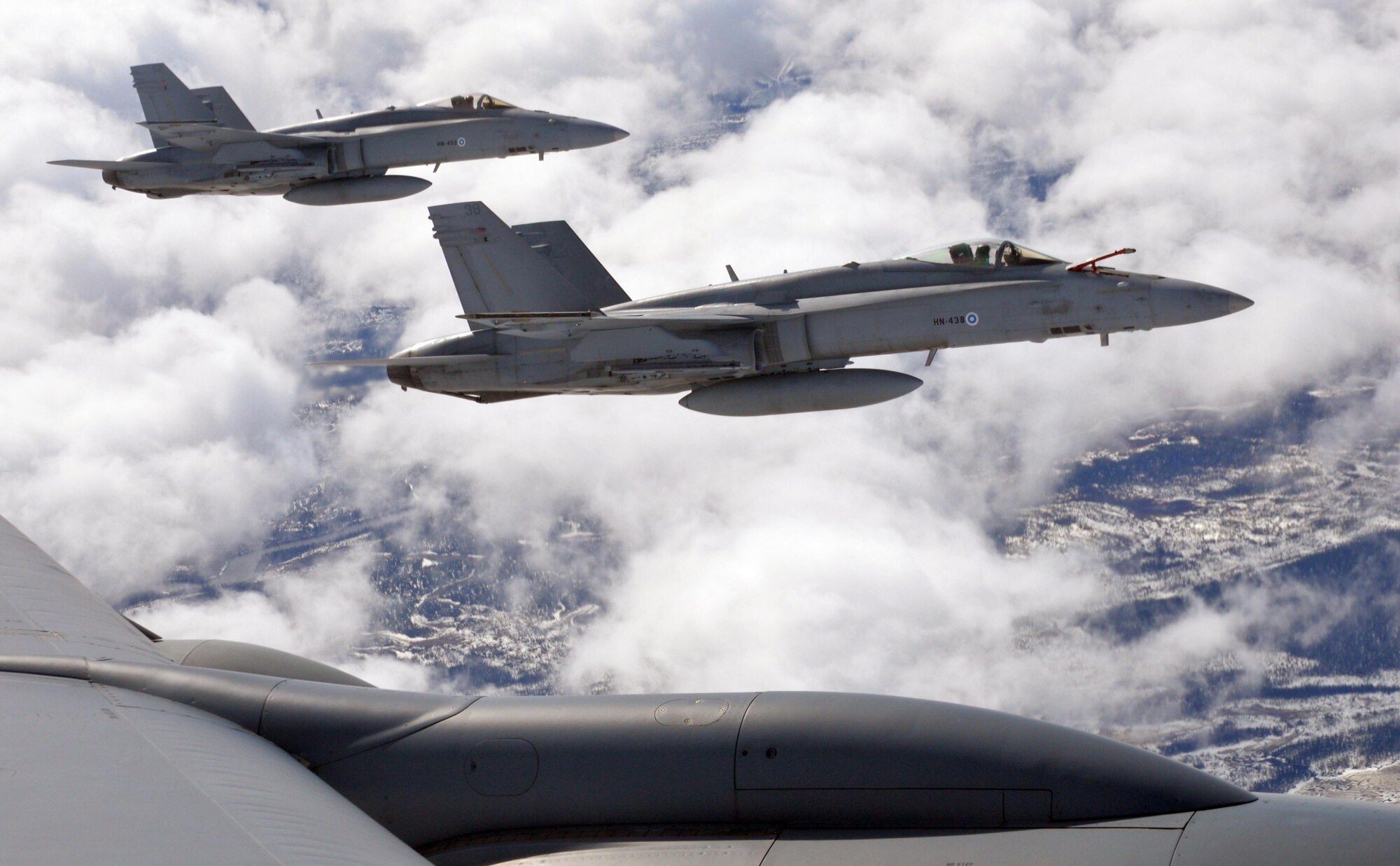 F-18 Hornets of the Finnish Air Force fly alongside a U.S. Air Force KC-135 Stratotanker from RAF Mildenhall, England, during aerial refueling over Finland, May 25, 2017. All three aircraft are participating in Arctic Challenge 2017, a multinational exercise encompassing 11 nations and more than 100 aircraft. (U.S. Air Force photo by Tech. Sgt. David Dobrydney)