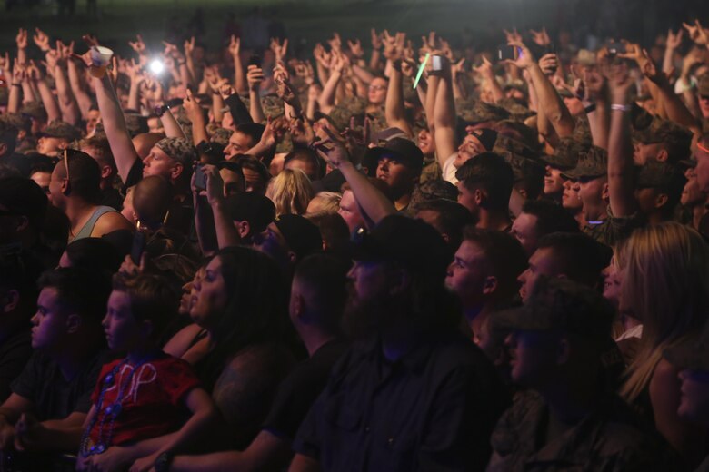 Combat Center patrons listen to Five Finger Death Punch perform at the We Salute You Celebration at Lance Cpl. Torrey L. Gray Field May 19, 2017. Marine Corps Community Services hosted the event to provide entertainment to Marines and sailors aboard the Combat Center. (U.S. Marine Corps photo by Lance Cpl. Christian Lopez)