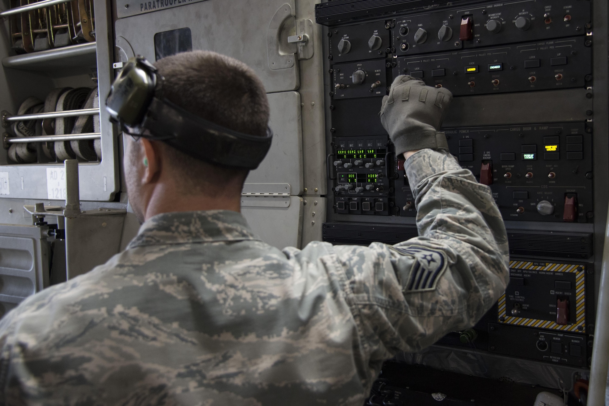 Staff Sgt. Brandon Metz, 436th Aerial Port Squadron aerial port expediter, releases cargo locks on a C-17 Globemaster III Jan. 12, 2017, at Dover Air Force Base, Del. APEX members operate loading and offloading of aircraft in lieu of loadmasters. (U.S. Air Force photo by Senior Airman Aaron J. Jenne)