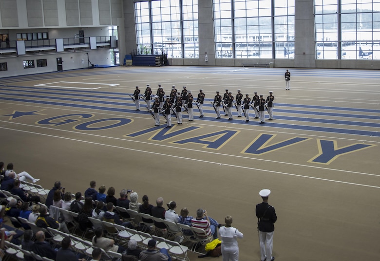 The U.S. Marine Corps Silent Drill Platoon executes precision rifle drill movements during a Battle Color Detachment Ceremony as a part of the 2017 United States Naval Academy Commissioning Week, Annapolis, Md., May 22, 2017. The U.S. Marine Corps Battle Color Detachment performed for hundreds of guests attending this year’s Commissioning Week events in which honor the First Class midshipmen upon their completion of their four years at the Academy. (Official Marine Corps photo by Cpl. Robert Knapp/Released)