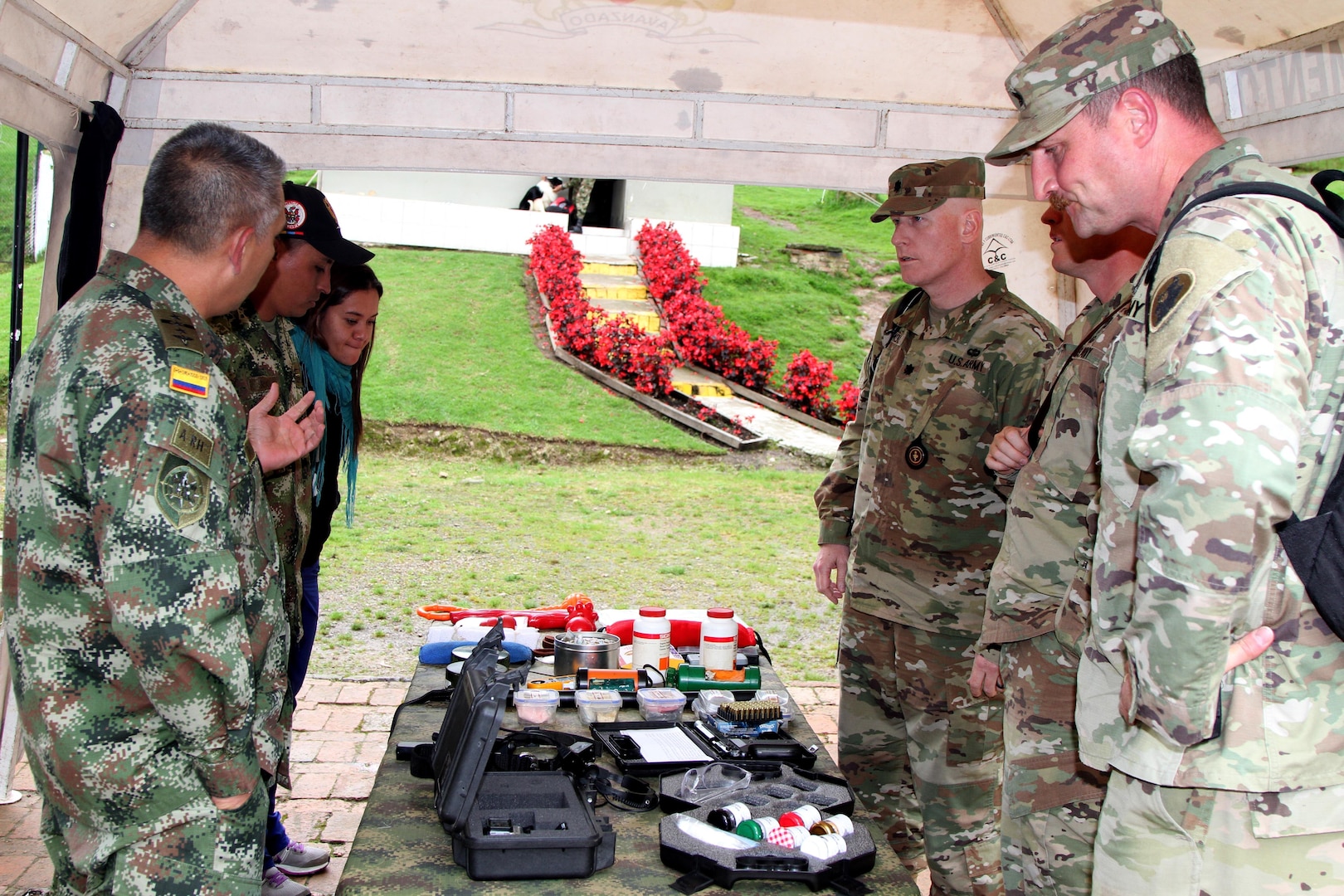 Col. Ramirez (left), Chief of Colombian Army Veterinary Services, explains to U.S. Army veterinarians how they use drug detection aids as part of their military working dogs training program. 
