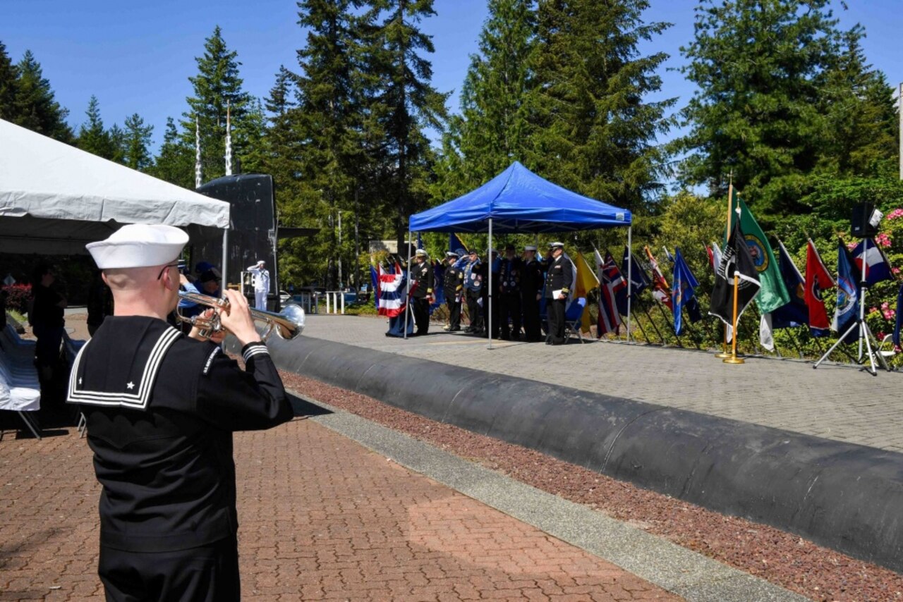 Navy Petty Officer 1st Class Christopher Hodges, assigned to Navy Band Northwest, plays “Taps” during the annual Memorial Day "Tolling the Boats" observance at Deterrent Park on Naval Base Kitsap in Washington, May 25, 2017. A total of 65 U.S. submarines have been lost since 1915, with 52 lost during World War II. Navy photo by Petty Officer 3rd Class Charles D. Gaddis IV