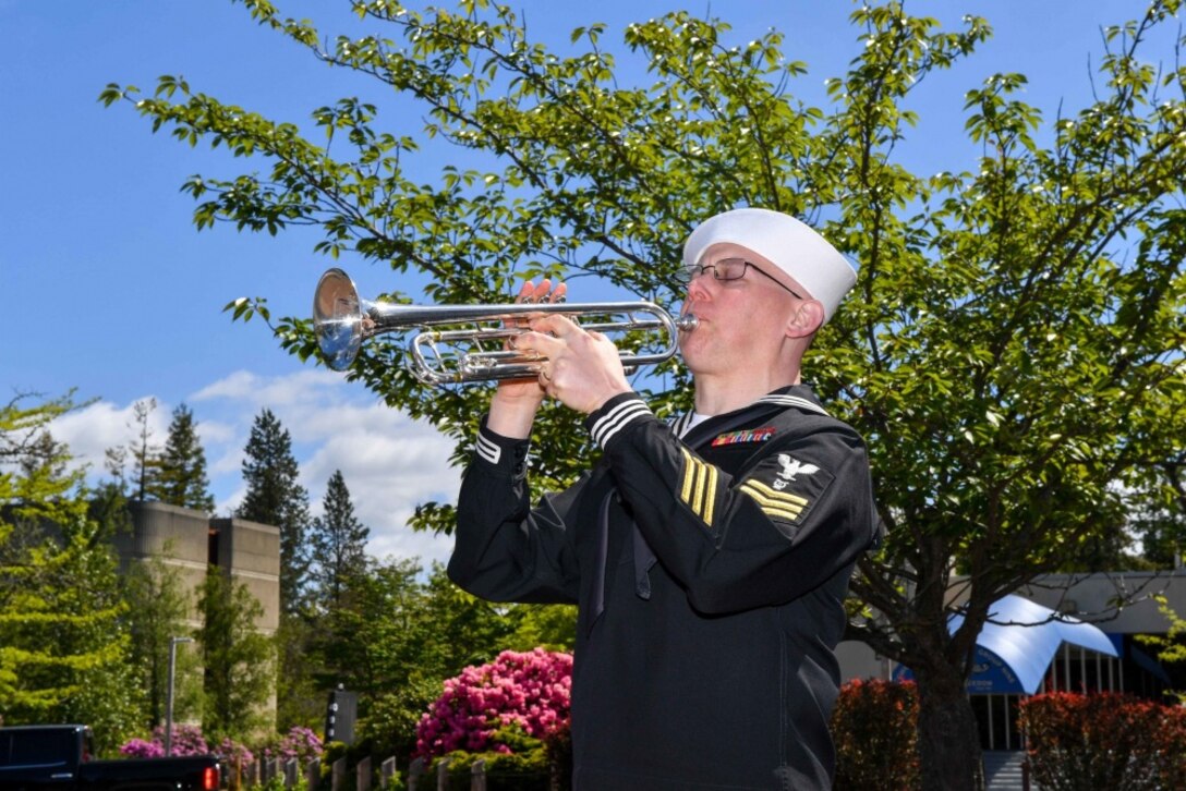 Navy Petty Officer 1st Class Christopher Hodges, assigned to Navy Band Northwest, plays “Taps” during the annual Memorial Day "Tolling the Boats" observance at Deterrent Park on Naval Base Kitsap in Washington, May 25, 2017. A total of 65 U.S. submarines have been lost since 1915, with 52 lost during World War II. Navy photo by Petty Officer 3rd Class Charles D. Gaddis IV