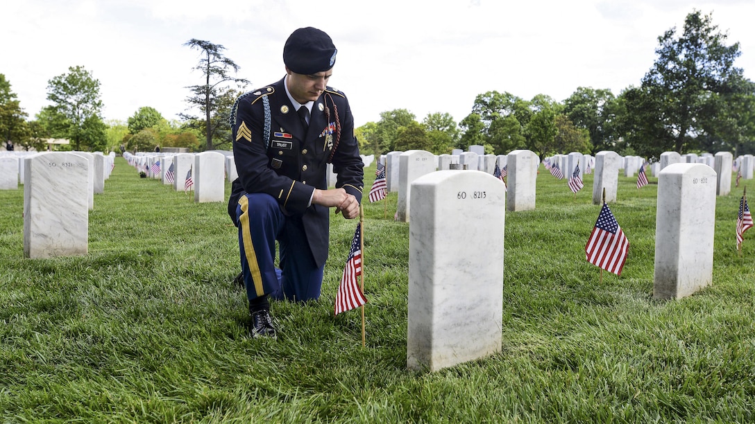 Army Sgt. Daniel Trust pays respects to his close friend, Army Capt. Jeremy A. Chandler, who was killed in action during Operation Enduring Freedom during  the Flags In ceremony at Arlington National Cemetery in Arlington, Va., May 25, 2017. DoD photo by Sebastian J. Sciotti Jr.
