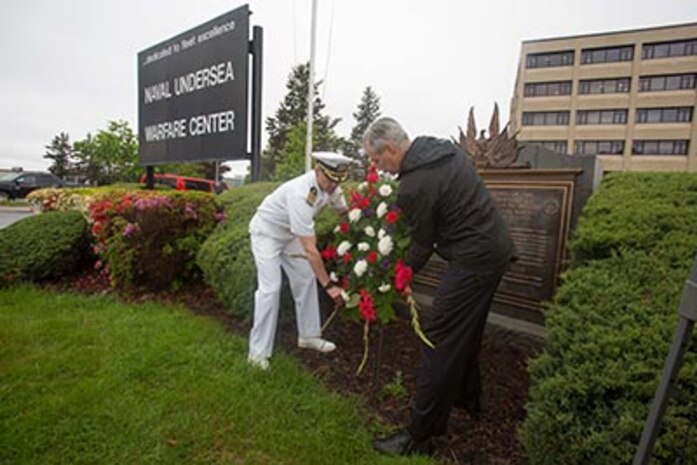 Capt. Michael Coughlin, NUWC Division Newport commanding officer, and U.S. Sen. Sheldon Whitehouse place a wreath at a memorial to the 32 men who lost their lives while working for predecessor organizations of NUWC. The ceremony was held after morning colors on Friday, May 26. (U.S. Navy photo/released)