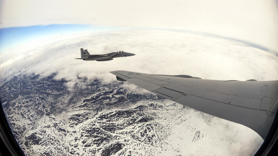 An Air Force F-15E Strike Eagle flies alongside an Air Force KC-135 Stratotanker after an aerial refueling over Finland, May 25, 2017. The aircraft are participating in Arctic Challenge 2017, a multinational exercise encompassing 11 nations and more than 100 aircraft. Air Force photo by Tech. Sgt. David Dobrydney