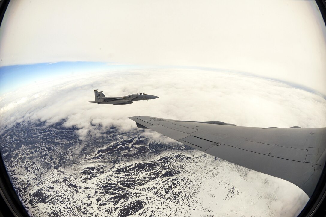 An Air Force F-15E Strike Eagle flies alongside an Air Force KC-135 Stratotanker after an aerial refueling over Finland, May 25, 2017. The aircraft are participating in Arctic Challenge 2017, a multinational exercise encompassing 11 nations and more than 100 aircraft. Air Force photo by Tech. Sgt. David Dobrydney