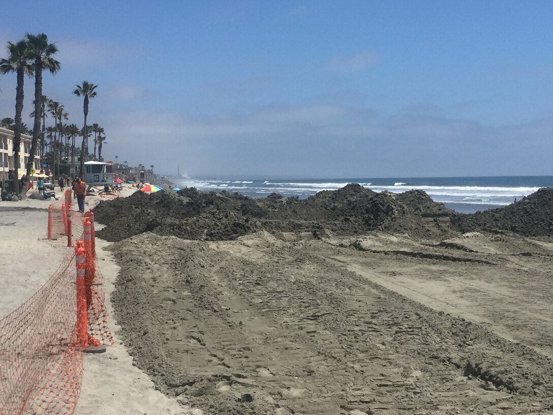 Beachgoers and lifeguards enjoy Oceanside Beach next to the southern end of the project that will place up to 420,000 cubic yards of beach-quality sand being dredged from the Oceanside Harbor entrance channel.