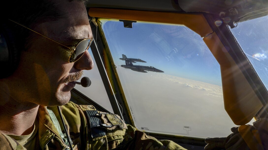 Air Force Capt. Timothy Black pilots a KC-135 Stratotanker on a combat refueling mission over Southwest Asia while two Navy F/A-18C Hornets fly alongside it, May 21, 2017. The Stratotanker is assigned to the 340th Expeditionary Air Refueling Squadron, which supports Operation Inherent Resolve. Air National Guard photo by Master Sgt. Andrew J. Moseley