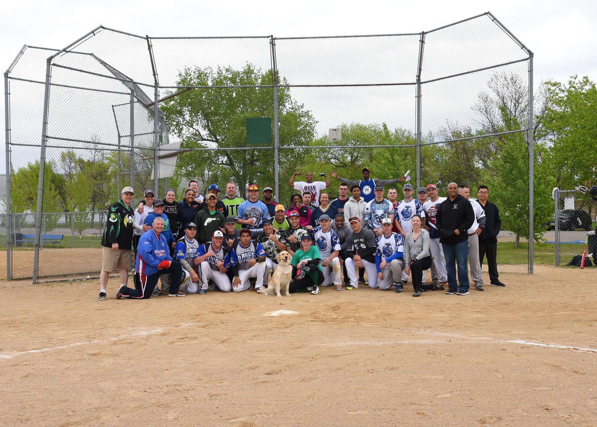 Players from both installations who participated in the Grand Forks AFB versus Minot AFB annual softball tournament May 25, 2017, at Devil’s Lake, N.D. gathered together after the final game to take a group picture. Minot took the trophy home, breaking Grand Forks’ two-year winning streak. (U.S. Air Force photo by Airman 1st Class Elora McCutcheon)
