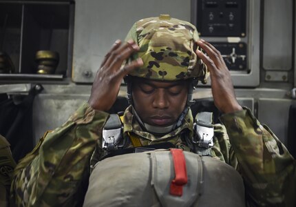 Army Staff Sgt. Primus Treavor, 82nd Airborne Division maintenance control supervisor, adjusts his helmet in a C-17 Globemaster III from Joint Base Charleston, S.C., May 25, 2017. The 82nd Abn. Div. celebrated their 100th anniversary during “All American Week” with a planned jump from the large formation exercise. 