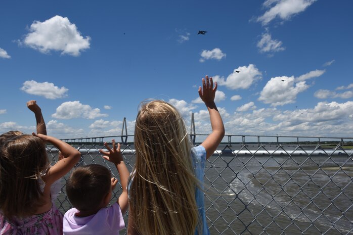 A group of children wave to a formation of C-17 Globemaster III aircraft from the 437th Airlift Wing, Joint Base Charleston, South Carolina, as they fly over the Arthur Ravenel Jr. Bridge in support of a global response force exercise on May 25. The multiple C-17 integrated large formation exercise supports the U.S. Army’s 82nd Airborne Division’s joint forcible entry exercise at Fort Bragg, North Carolina, during their All American Week and 100th Anniversary. 