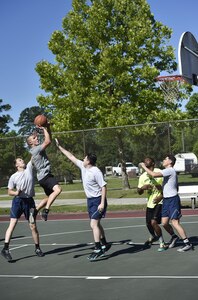 Staff Sgt. Shawn Montgomery, 437th Maintenance Squadron, takes a shot during a basketball game against Airmen of the 437th Aircraft Maintenance Squadron as part of the 437th Airlift Wing picnic at Joint Base Charleston, S.C., May 26. Attendees were able to compete in sports and play games during the event such as basketball, dodge ball, tug-of-war and ultimate Frisbee. (U.S. Air Force photo by Staff Sgt. Christopher Hubenthal)