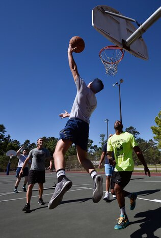 Airmen of the 437th Maintenance Squadron and 437th Aircraft Maintenance Squadron compete during a basketball game as part of the 437th Airlift Wing picnic at Joint Base Charleston, S.C., May 26. Attendees were able to compete in sports and play games during the event such as basketball, dodge ball, tug-of-war and ultimate Frisbee. (U.S. Air Force photo by Staff Sgt. Christopher Hubenthal)