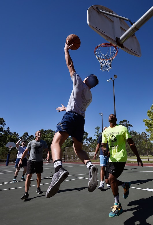 Airmen of the 437th Maintenance Squadron and 437th Aircraft Maintenance Squadron compete during a basketball game as part of the 437th Airlift Wing picnic at Joint Base Charleston, S.C., May 26. Attendees were able to compete in sports and play games during the event such as basketball, dodge ball, tug-of-war and ultimate Frisbee. (U.S. Air Force photo by Staff Sgt. Christopher Hubenthal)