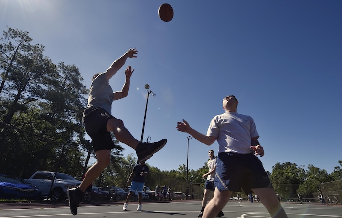 Staff Sgt. Shawn Montgomery, 437th Maintenance Squadron, takes a shot during a basketball game against Airmen of the 437th Aircraft Maintenance Squadron as part of the 437th Airlift Wing picnic at Joint Base Charleston, S.C., May 26. Attendees were able to compete in sports and play games during the event such as basketball, dodge ball, tug-of-war and ultimate Frisbee. (U.S. Air Force photo by Staff Sgt. Christopher Hubenthal)