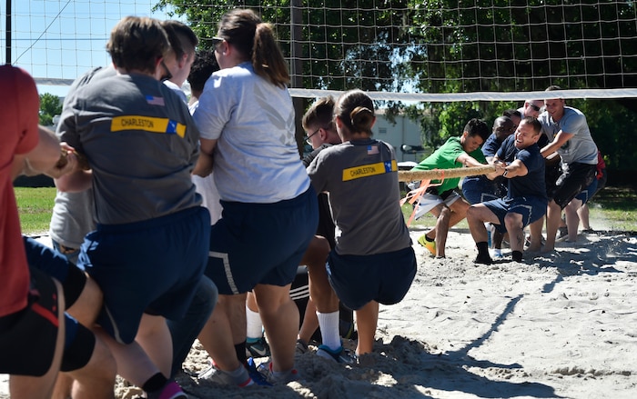 Airmen of the 437th Maintenance Squadron, background, and Airmen of the 437th Aircraft Maintenance Squadron, compete in tug-of-war as part of the 437th Airlift Wing picnic at Joint Base Charleston, S.C., May 26. Attendees were able to compete in sports and play games during the event such as basketball, dodge ball, tug-of-war and ultimate Frisbee. (U.S. Air Force photo by Staff Sgt. Christopher Hubenthal)