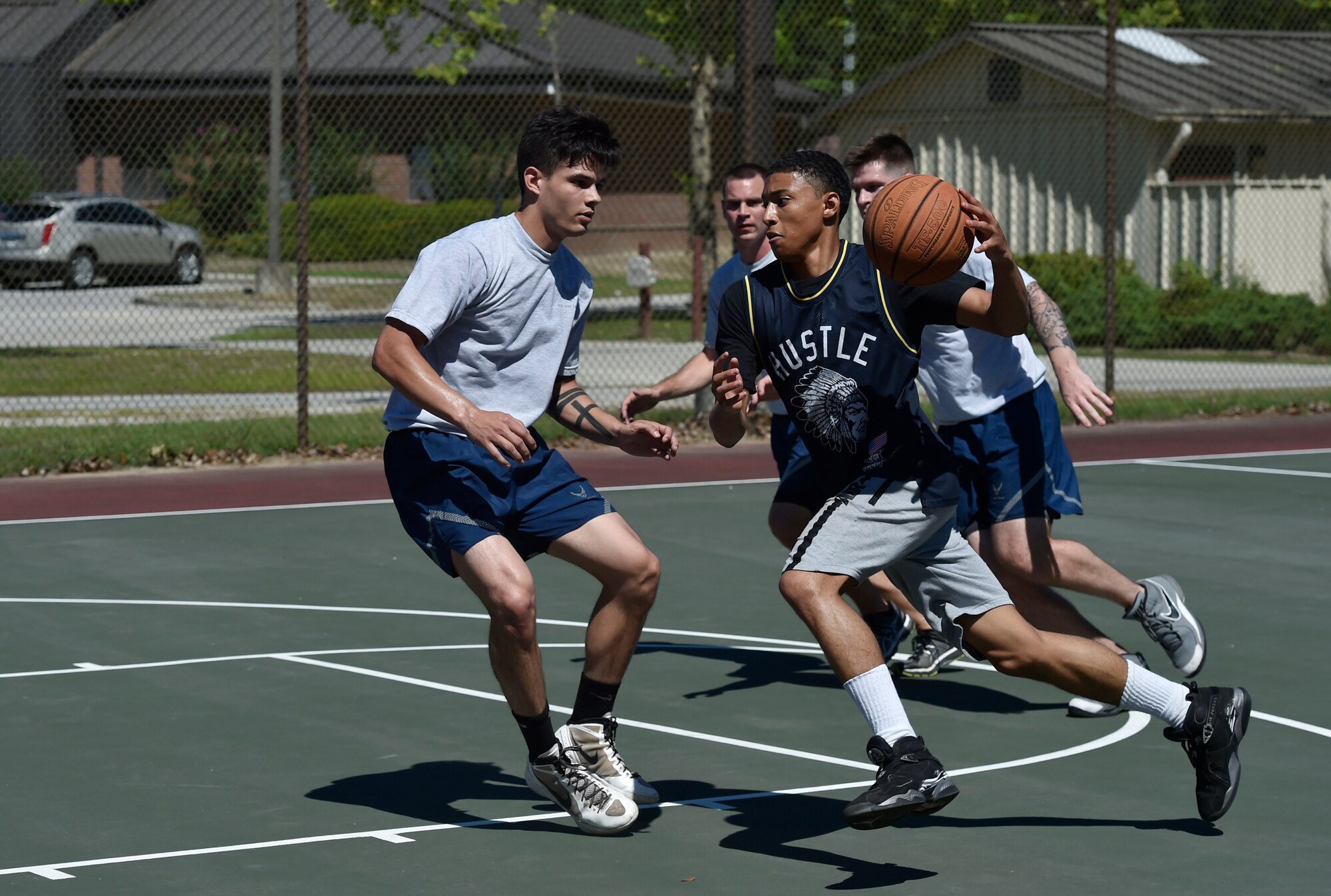 Amn Saabir Brown, 437th Maintenance Squadron, charges down the court during a basketball game as part of the 437th Airlift Wing picnic at Joint Base Charleston, S.C., May 26. Attendees were able to compete in sports and play games during the event such as basketball, dodge ball, tug-of-war and ultimate Frisbee. (U.S. Air Force photo by Staff Sgt. Christopher Hubenthal)