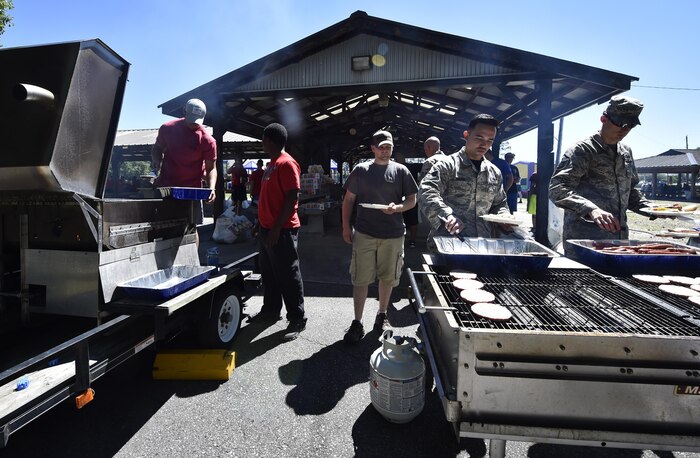 Airmen and civilians prepare lunch during the 437th Airlift Wing picnic at Joint Base Charleston, S.C., May 26. Attendees were able to compete in sports and play games during the event such as basketball, dodge ball, tug-of-war and ultimate Frisbee. (U.S. Air Force photo by Staff Sgt. Christopher Hubenthal)