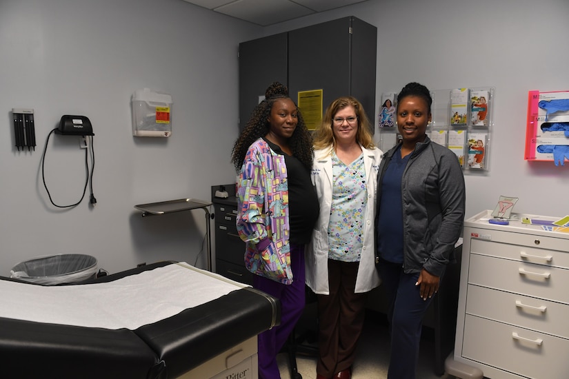 Jessica Bryant, left, 628th Medical Group Women’s Health Clinic licensed practical nurse, Cynthia Adams, center, 628th MDG Women’s Health Clinic nurse practitioner, and Senovia Linnen, right, 628th MDG Women’s Health Clinic registered nurse, showcase the Women’s Health Clinic here, May 23, 2017. The clinic provides specialized women’s healthcare including cancer screenings, post-partum care, hormonal replacement therapy and infertility treatments. 