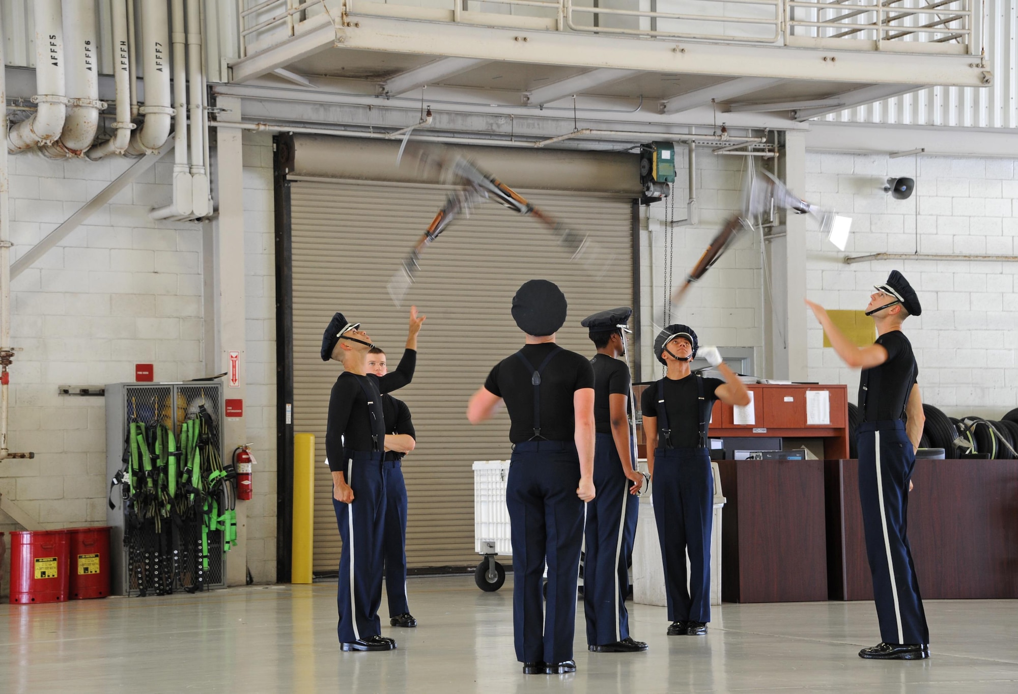 The U.S. Air Force Honor Guard Drill Team, stationed at Joint Base Anacostia-Bolling, Washington, D.C., practices drill movements before a U.S. Armed Forces Delayed Entry Program swear-in ceremony during the Memorial Day weekend National Salute to America’s Heroes Miami Air and Sea Show at U.S. Coast Guard Air Station Miami in Opa-Locka, Fla., May 26, 2017. The joint-service event allows the five branches of the Armed Forces to demonstrate and educate the public on their asset’s capabilities, and increases awareness and understanding of each branch’s unique mission. (U.S. Air Force photo by Senior Airman Erin Trower)