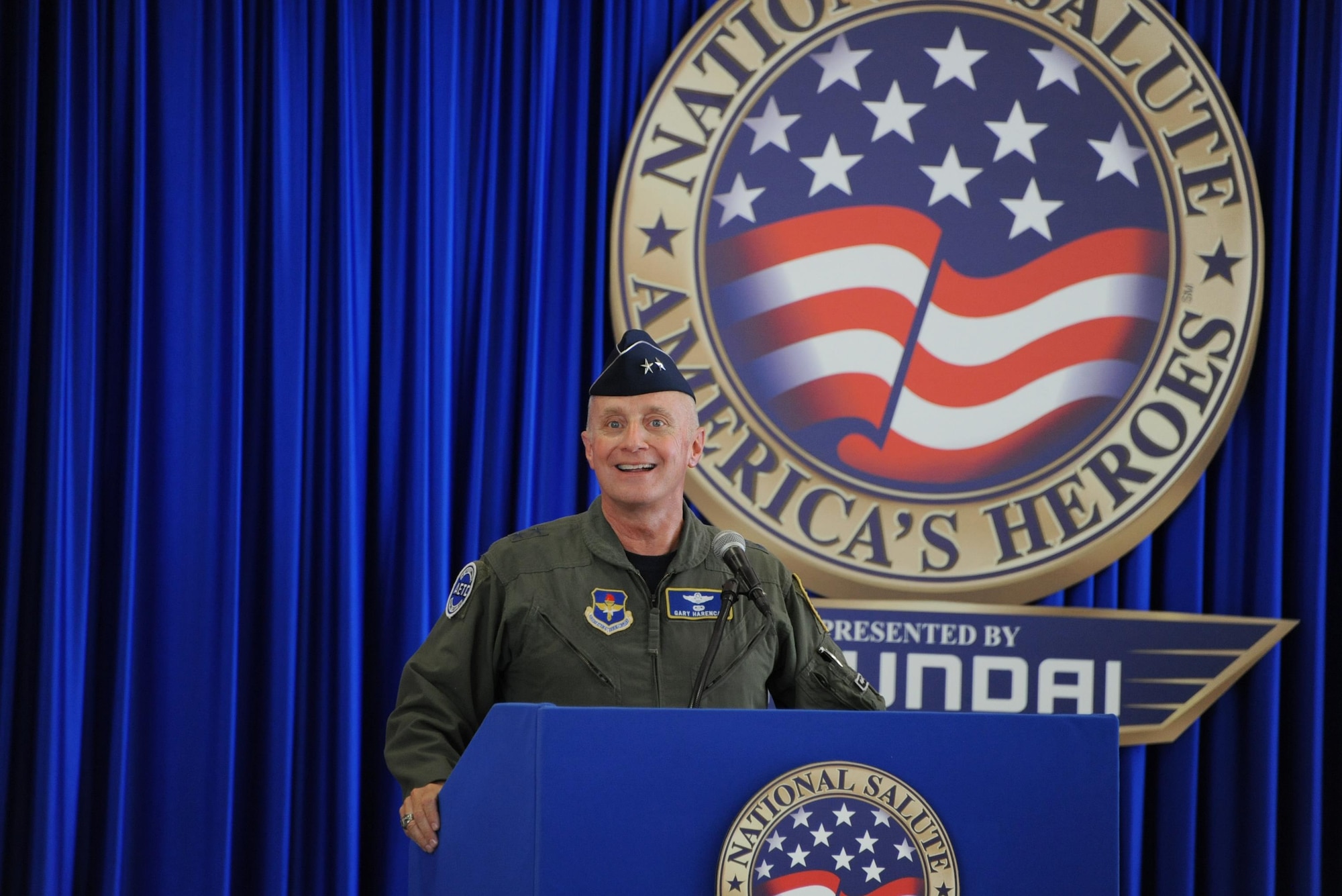 Air Force Maj. Gen. Garrett Harencak, Air Force Recruiting Service commander, speaks during the Memorial Day weekend National Salute to America’s Heroes Miami Air and Sea Show at U.S. Coast Guard Air Station Miami in Opa-Locka, Fla., May 26, 2017. Air Force, Army, Navy, Marine Corps, and Coast Guard Delayed Entry Program recruits took the Oath of Enlistment during a swear-in ceremony in which Harencak provided words of encouragement and gratitude. (U.S. Air Force photo by Senior Airman Erin Trower)