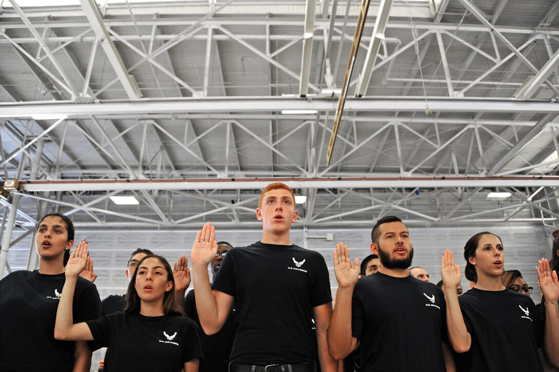 Air Force Delayed Entry Program recruits are sworn in during a U.S. Armed Services swear-in ceremony during the Memorial Day weekend National Salute to America’s Heroes Miami Air and Sea Show at U.S. Coast Guard Air Station Miami in Opa-Locka, Fla., May 26, 2017. Department of Defense service members, DEP family members, and guests witnessed approximately 97 Air Force recruits took the Oath of Enlistment, along with Army, Navy, Marine Corps, and Coast Guard recruits. (U.S. Air Force photo by Senior Airman Erin Trower)