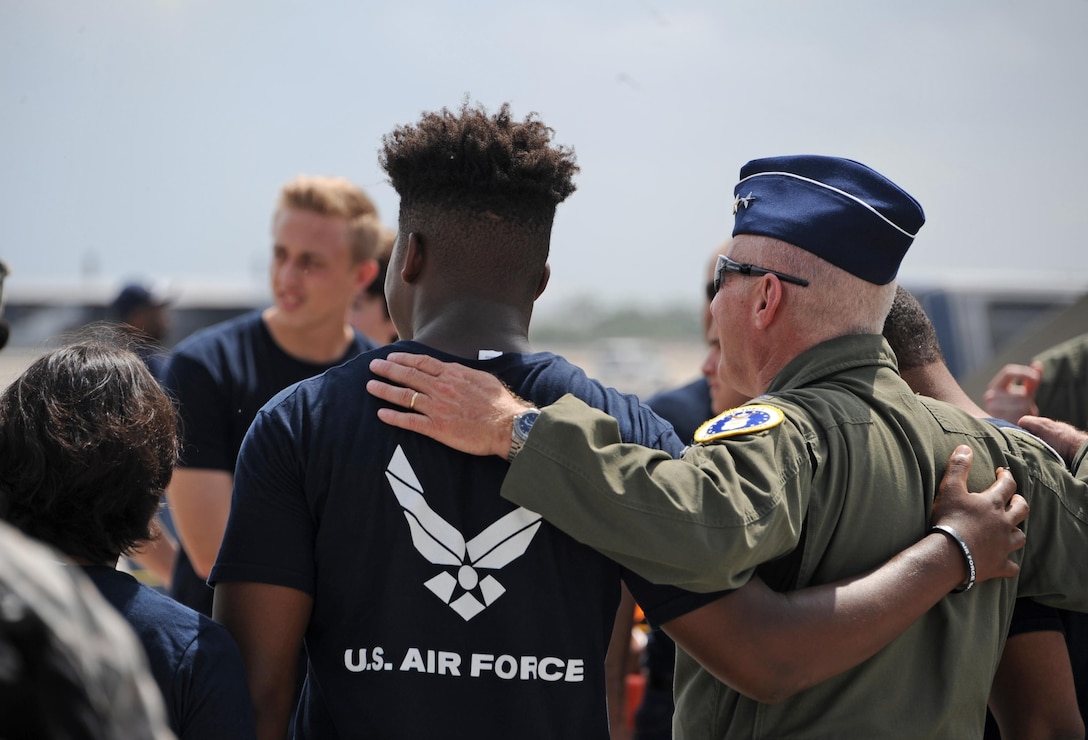 Air Force Maj. Gen. Garrett Harencak, Air Force Recruiting Service commander, stands for a photo with Delayed Entry Program Air Force recruits during the Memorial Day weekend National Salute to America’s Heroes Miami Air and Sea Show at U.S. Coast Guard Air Station Miami in Opa-Locka, Fla., May 26, 2017. A swear-in ceremony was held to recognize new recruits who took the Oath of Enlistment into the U.S. Armed Forces. Approximately 97 Air Force recruits were sworn-in during the joint-service event which is held to educate the public, and increases awareness and understanding of each branch’s unique mission. (U.S. Air Force photo by Senior Airman Erin Trower)