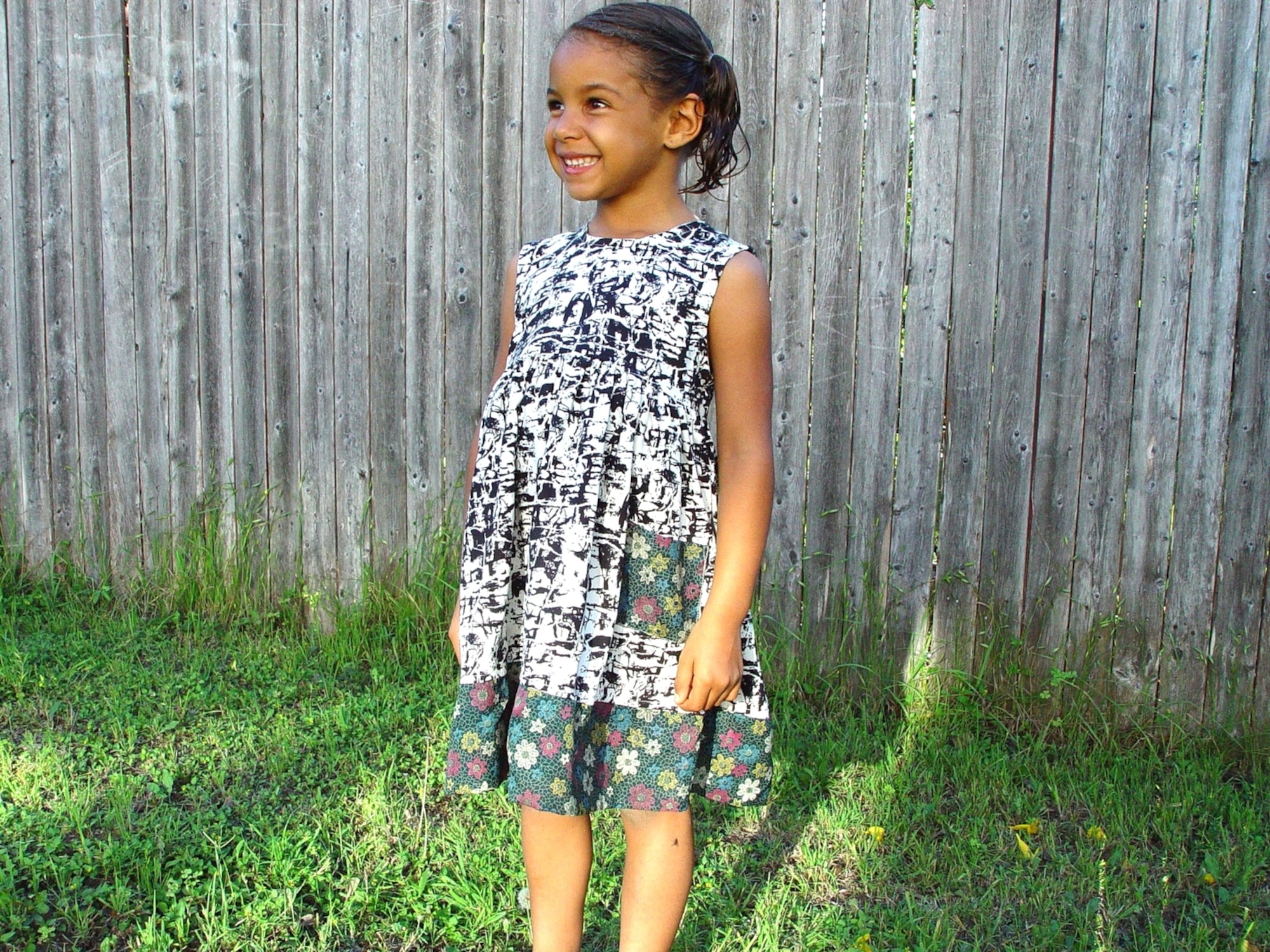 One of the designs for girls dresses from Evan Brooke’s clothing line, modeled by one of her daughters, Kimmie, age 7. The clothing line provides jobs and assistance to those affected by human trafficking. (Courtesy photo)