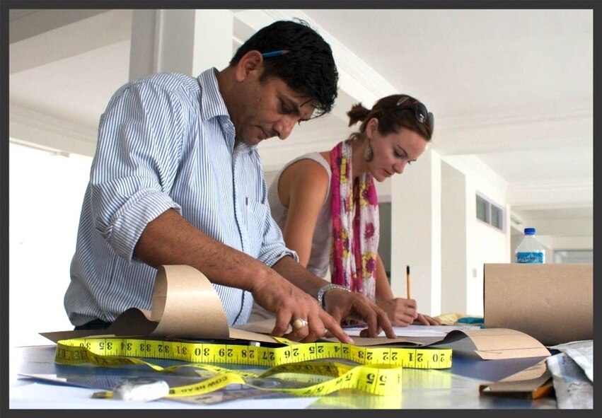 Evan Menendez, owner of Evan Brooke Ethical Clothing with a Master Tailor at Purnaa, working on her clothing line. The clothing line provides jobs and assistance to those affected by human trafficking. (Courtesy photo)