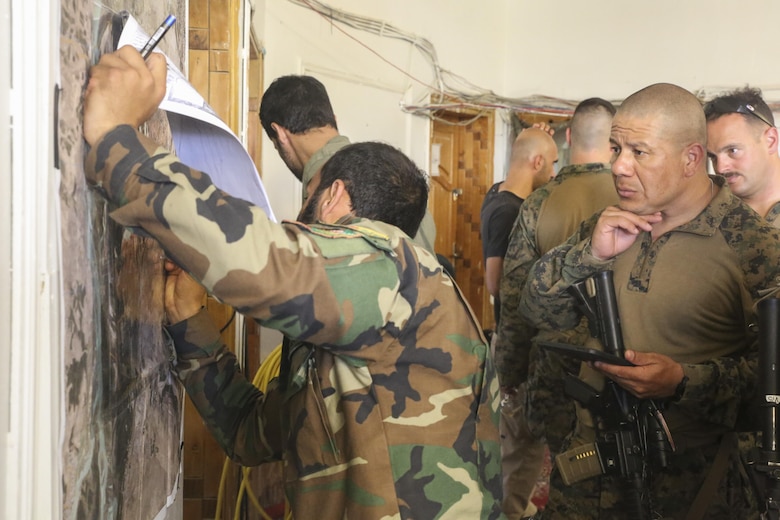An Afghan National Army soldier with 2nd Brigade, 215th Corps and U.S. Marine advisors with Task Force Southwest plan for a clearing operation at Camp Nolay, Afghanistan, May 22, 2017. The advisors assisted their counterparts with the battle-tracking, intelligence and logistical procedures during a clearing operation in Sangin, Afghanistan. Approximately 50 Marines partook in the expeditionary advising package as part of the Task Force’s train, advise and assist mission in Helmand Province. (U.S. Marine Corps photo by Sgt. Lucas Hopkins)