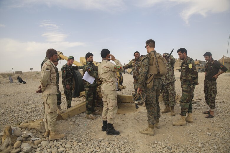 A U.S. Marine advisor with Task Force Southwest speaks with Afghan National Army soldiers with the 2nd Brigade, 215th Corps on artillery capabilities and tactics at Camp Nolay, Afghanistan, May 22, 2017. Several Marine advisors assisted their Afghan counterparts during an expeditionary advising package May 21-25, providing force sustainment recommendations as well as assisting in the coordination of a clearing operation to help thwart enemy presence in the Sangin District. (U.S. Marine Corps photo by Sgt. Lucas Hopkins)