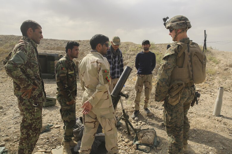 A U.S. Marine advisor assigned to Task Force Southwest inspects an 81mm mortar with Afghan National Army soldiers with the 2nd Brigade, 215th Corps at Camp Nolay, Afghanistan, May 22, 2017. Approximately 10 Marines aided in the facilitation of a clearing operation alongside their Afghan counterparts and made recommendations for improving force sustainment during an expeditionary advising package May 21-25. The EAP was part of the Task Force’s role as the main advisory element in Helmand Province, helping to deny safe havens to insurgents in the region. (U.S. Marine Corps photo by Sgt. Lucas Hopkins)