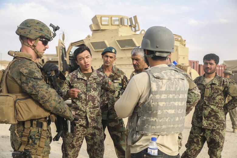 A U.S. Marine advisor with Task Force Southwest speaks with Afghan National Army soldiers with the 2nd Brigade, 215th Corps on vehicle repairs and improvements at Camp Nolay, Afghanistan, May 22, 2017. Approximately 10 advisors with the Task Force conducted an expeditionary advising package alongside their Afghan counterparts, aiding in the facilitation of a clearing operation and addressing force sustainment procedures. (U.S. Marine Corps photo by Sgt. Lucas Hopkins)