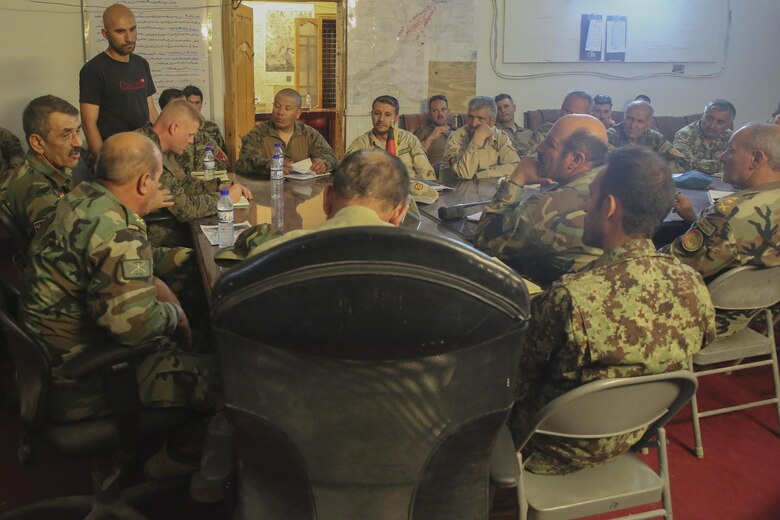 Afghan National Army soldiers with the 2nd Brigade, 215th Corps and U.S. Marine advisors with Task Force Southwest gather for a meeting at Camp Nolay, Afghanistan, May 22, 2017. The advisors addressed force sustainment procedures and helped facilitate a clearing operation with their Afghan counterparts during an expeditionary advising package May 21-25. The EAP allowed for the Marines to bring their skills and knowledge to the 2nd Brigade, 215th Corps, helping to bolster security and stability in the Sangin District of Helmand Province. (U.S. Marine Corps photo by Sgt. Lucas Hopkins)