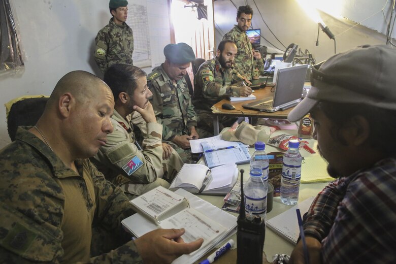 A U.S. Marine advisor with Task Force Southwest and Afghan National Army soldiers with 2nd Brigade, 215th Corps monitor battlefield operations at the Brigade’s command operations center in Camp Nolay, Afghanistan, May 23, 2017. Approximately 10 advisors completed an expeditionary advising package May 21-25, helping to facilitate a clearing operation conducted by 3rd Kandak, 2nd Brigade, and worked to improve force sustainment procedures with their Afghan counterparts. (U.S. Marine Corps photo by Sgt. Lucas Hopkins)