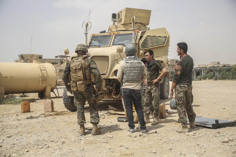 A U.S. Marine advisor with Task Force Southwest and Afghan National Army soldiers with 2nd Brigade, 215th Corps address vehicle maintenance and logistics at Camp Nolay, Afghanistan, May 23, 2017. Marine advisors travelled to the Sangin District of Helmand Province for an expeditionary advising package May 21-25, helping to coordinate a clearing operation as well as providing force sustainment recommendations for the 2nd Brigade. (U.S. Marine Corps photo by Sgt. Lucas Hopkins)