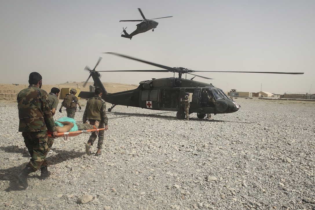 Afghan National Army soldiers with 2nd Brigade, 215th Corps evacuate a wounded ANA soldier at Camp Nolay, Afghanistan, May 23, 2017. Approximately 50 Marines aided in the facilitation of a clearing operation alongside their Afghan counterparts and made recommendations for improving force sustainment during an expeditionary advising package May 21-25. The EAP was part of the Task Force’s role as the main advisory element in Helmand Province, helping to deny safe havens to insurgents in the region. (U.S. Marine Corps photo by Sgt. Lucas Hopkins)