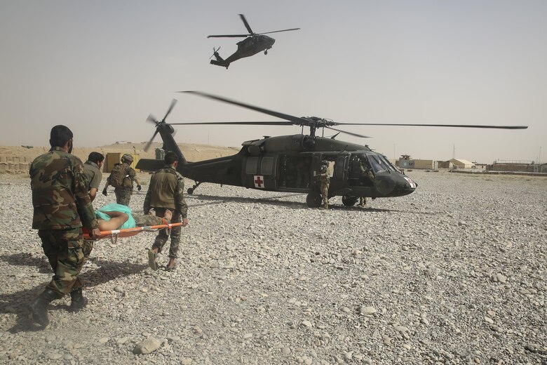 Afghan National Army soldiers with 2nd Brigade, 215th Corps evacuate a wounded ANA soldier at Camp Nolay, Afghanistan, May 23, 2017. Approximately 50 Marines aided in the facilitation of a clearing operation alongside their Afghan counterparts and made recommendations for improving force sustainment during an expeditionary advising package May 21-25. The EAP was part of the Task Force’s role as the main advisory element in Helmand Province, helping to deny safe havens to insurgents in the region. (U.S. Marine Corps photo by Sgt. Lucas Hopkins)