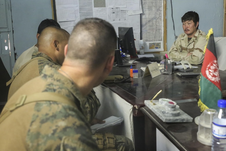 U.S. Marines assigned to Task Force Southwest speak with an Afghan National Army soldier with 2nd Brigade, 215th Corps at Camp Nolay, Afghanistan, May 24, 2017. Several Marine advisors assisted their Afghan counterparts during an expeditionary advising package May 21-25, providing force sustainment recommendations as well as assisting in the coordination of a clearing operation to help thwart enemy presence in the Sangin District. (U.S. Marine Corps photo by Sgt. Lucas Hopkins)