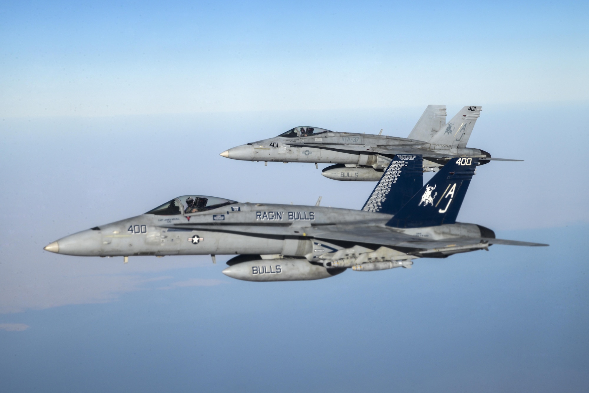 Two U.S. Navy F/A-18Cs from the Strike Fighter Squadron VFA-37 Ragin' Bulls fly in formation alongside a U.S. Air Force KC-135 Stratotanker during a combat refueling mission over Southwest Asia May 21, 2017.  KC-135 Stratotankers, from the 340th Expeditionary Air Refueling Squadron at Al Udeid Air Base, Qatar, maintain a 24/7 presence in the Area Of Responsibility, supporting U.S. and Coalition forces in the air and on the ground, contributing to Operation Inherent Resolve and the fight against ISIS. (U.S. Air National Guard photo by Master Sgt. Andrew J. Moseley/Released)