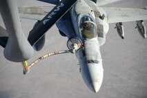 A U.S. Navy F/A-18C from the Strike Fighter Squadron VFA-37 Ragin' Bulls receives fuel in flight from a U.S. Air Force KC-135 Stratotanker over Southwest Asia May 21, 2017. Assigned to the 340th Expeditionary Air Refueling Squadron, out of Al Udeid Air Base, Qatar, the tanker from the 186th Air Refueling Wing, Mississippi Air National Guard was fitted with a drogue attached to the boom, for specialized receiver equipment on Navy and coalition aircraft. The 340th EARS maintains a 24/7 presence in the AOR, extending the missions of aircraft supporting Operation Inherent Resolve and the fight against ISIS. (U.S. Air National Guard photo by Master Sgt. Andrew J. Moseley/Released)