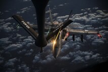 A U.S. Navy F/A-18C from the VFA-37 Ragin' Bulls prepares to receive fuel from a U.S. Air Force KC-135 Stratotanker over Southwest Asia May 21, 2017. Assigned to the 340th Expeditionary Air Refueling Squadron, Al Udeid Air Base, Qatar, the tanker from the 186th Air Refueling Wing, Mississippi Air National Guard is fitted with a drogue attached to the boom, for specialized receiver equipment on Navy and coalition aircraft. The 340 EARS tankers maintain a 24/7 presence in the Area Of Responsibility, supporting U.S. and coalition aircraft participating in Operation Inherent Resolve and the fight against ISIS. (U.S. Air National Guard photo by Master Sgt. Andrew J. Moseley/Released)